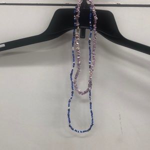 blue beaded necklace and a purple shell necklace